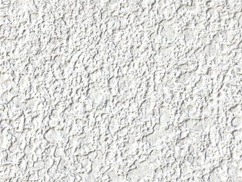 Détail d’une façade recouverte d’un crépi projeté blanc à grain fin